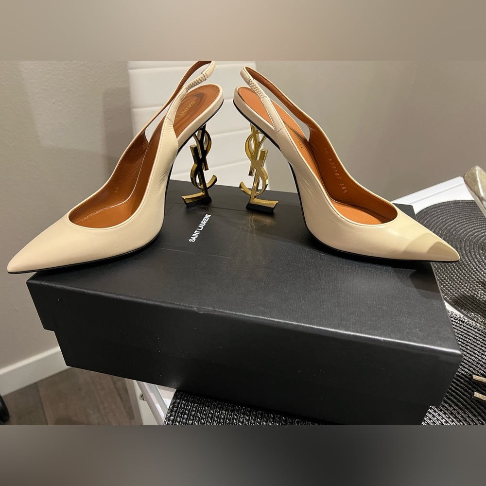 YSL A sculpted logo heel anchors these sleek calfskin pumps